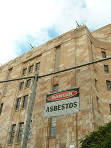 asbestos sign in front of building